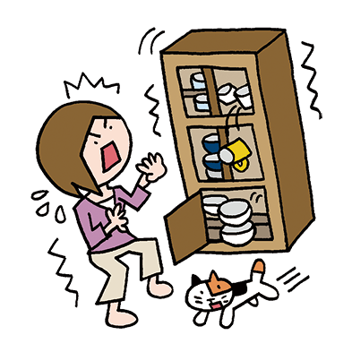 地震で食器棚が倒れそうになる驚く女性